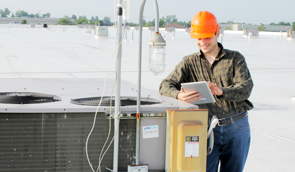 HVAC tech using mobile technology.