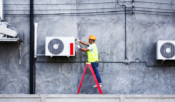 An HVAC technician implements a field service management strategy.